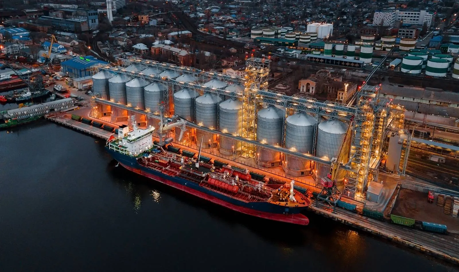 Grain terminal and vessel at a working port at dusk